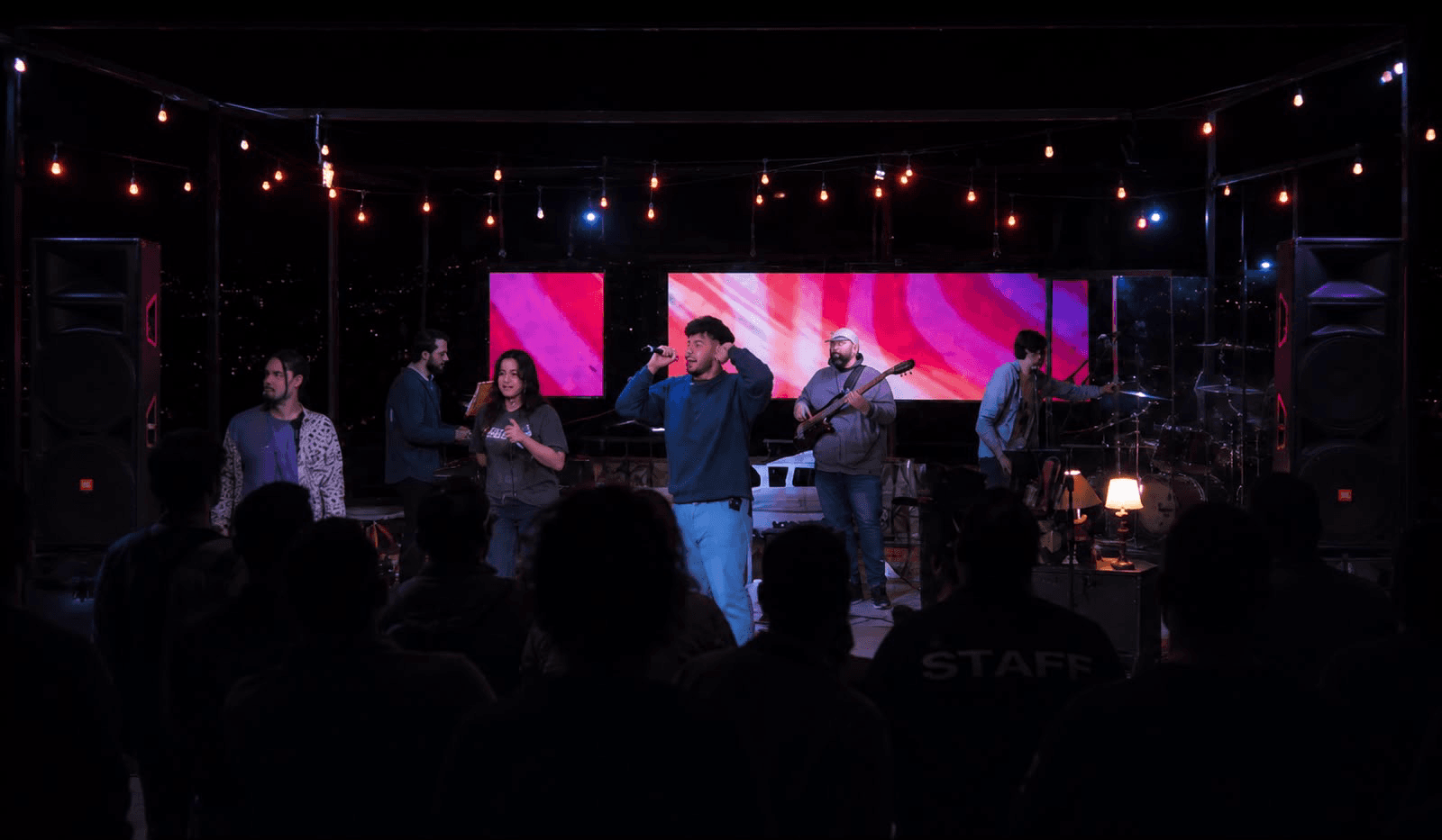 Band performing live on stage for an audience